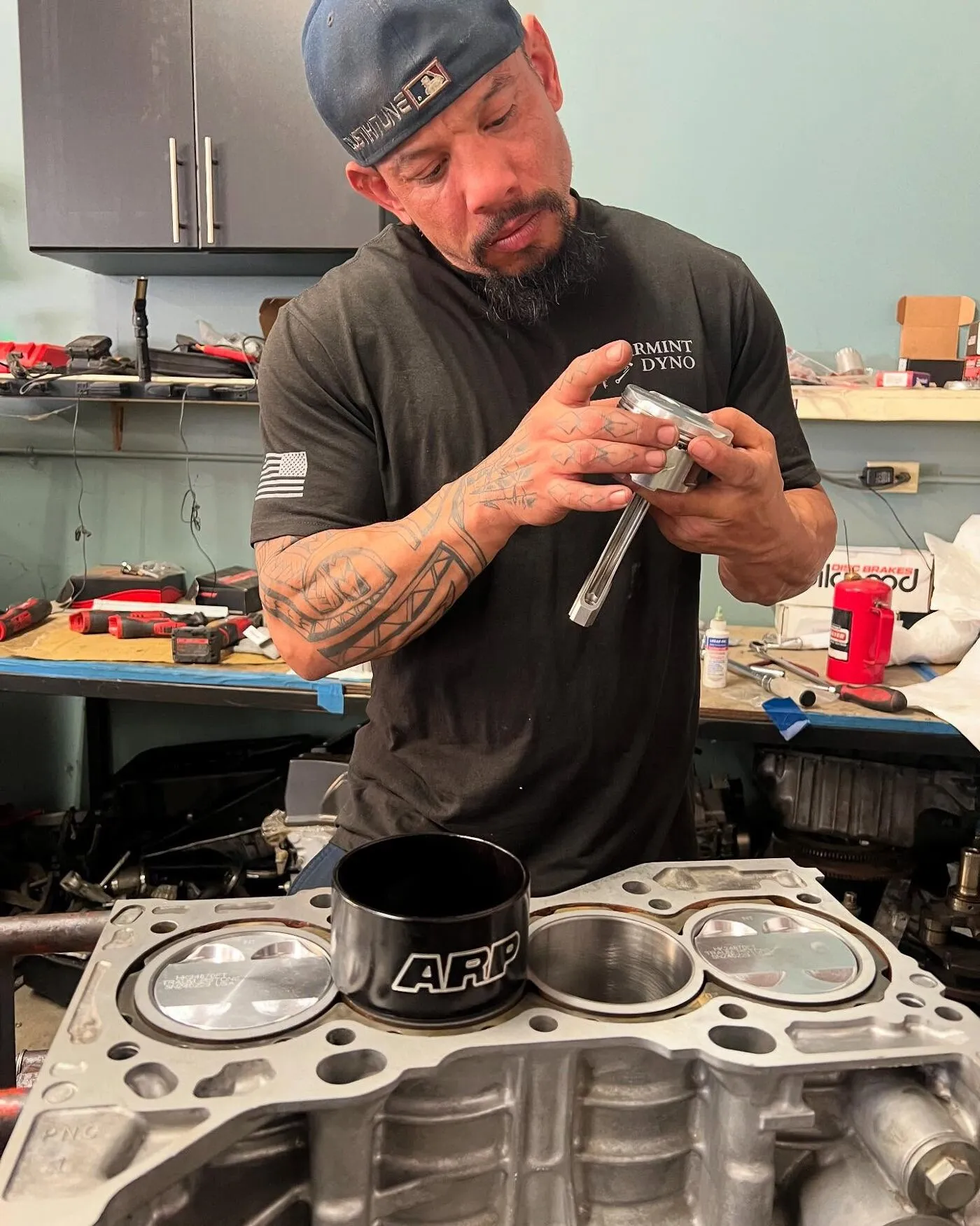 Dustin, co-owner of Spearmint Dyno, working on an engine at the bench